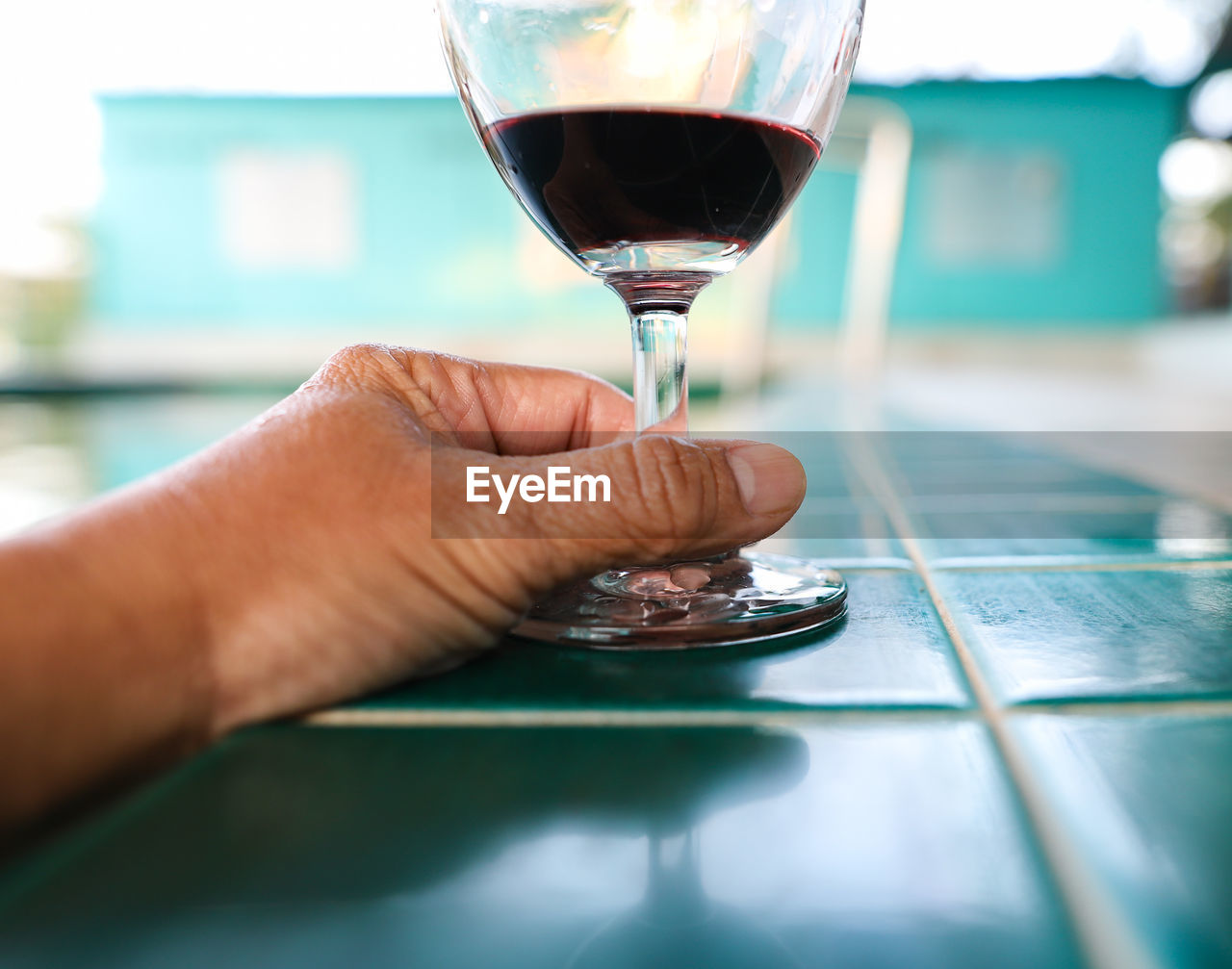 Close-up of hand holding wine glass 