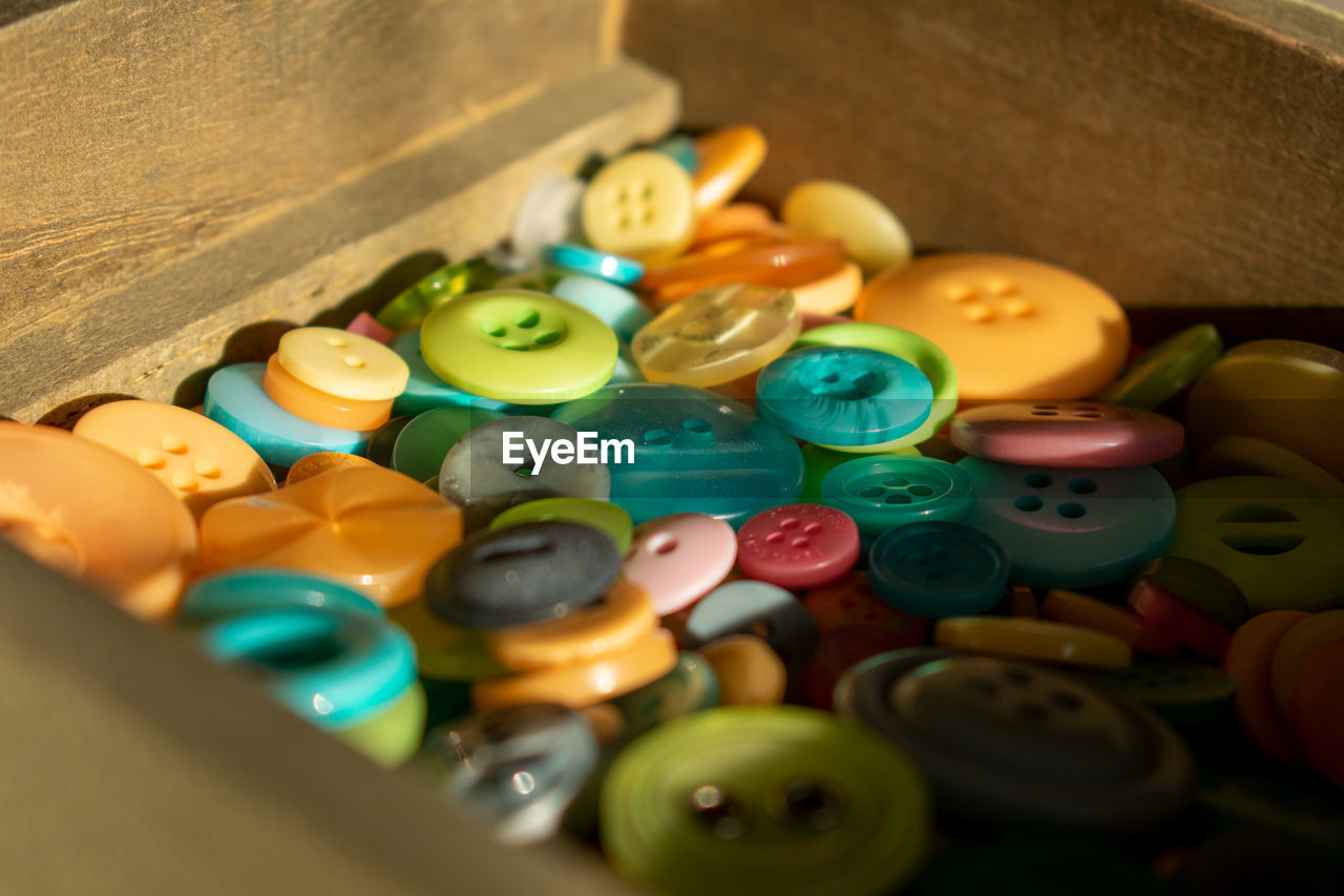 Close-up of buttons in container