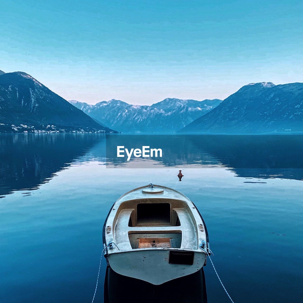 Scenic view of lake by mountains against sky