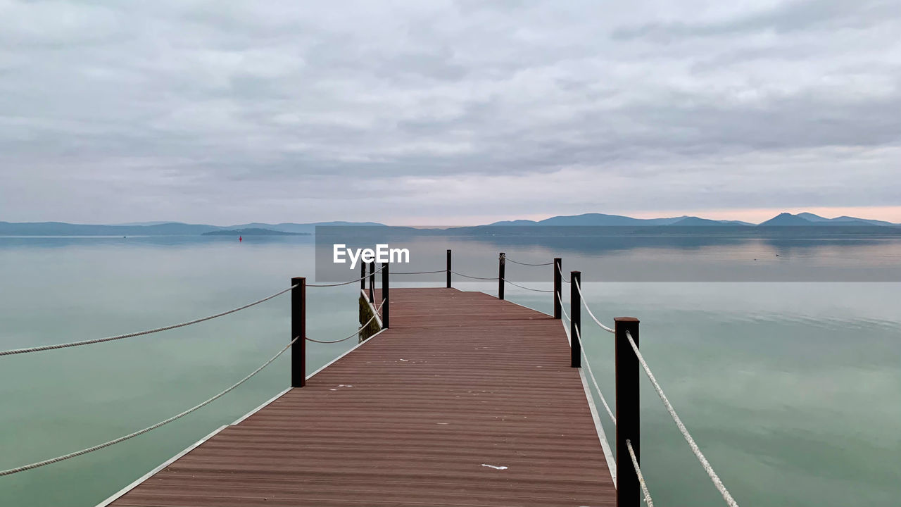 Fog over lake pier atmosphere