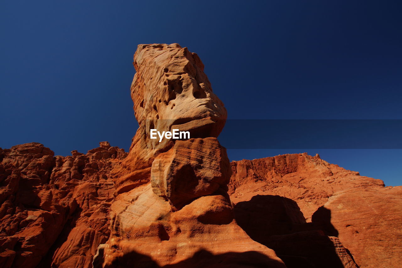 LOW ANGLE VIEW OF ROCK FORMATIONS AGAINST SKY