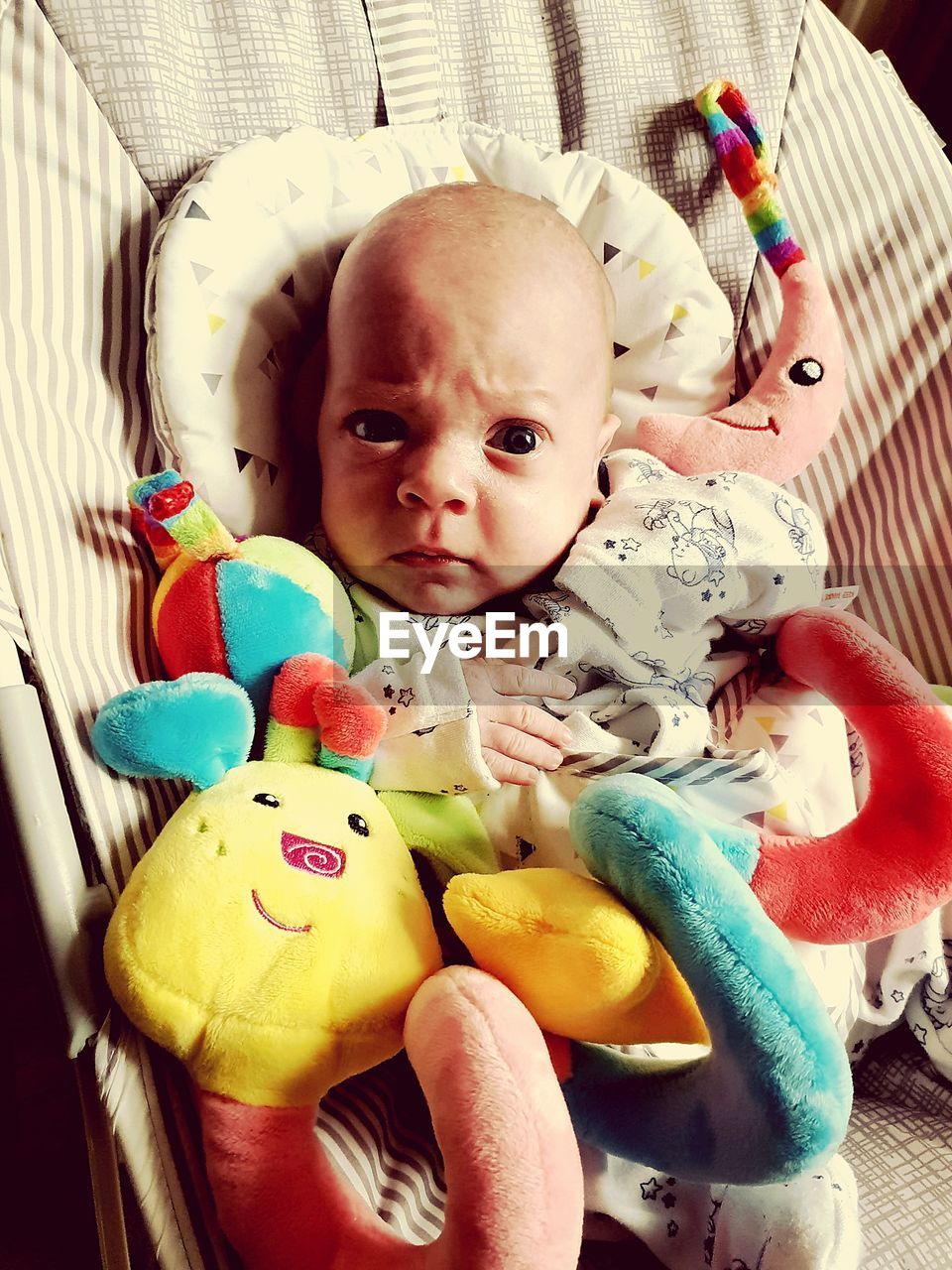 PORTRAIT OF CUTE BABY WITH TOY IN TOYS