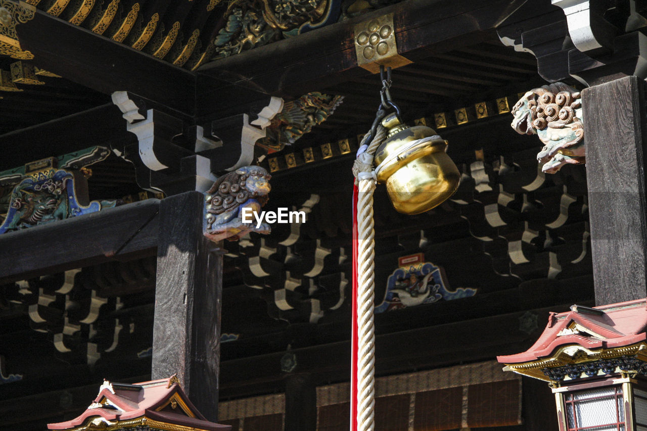 LOW ANGLE VIEW OF LANTERNS HANGING OUTSIDE BUILDING