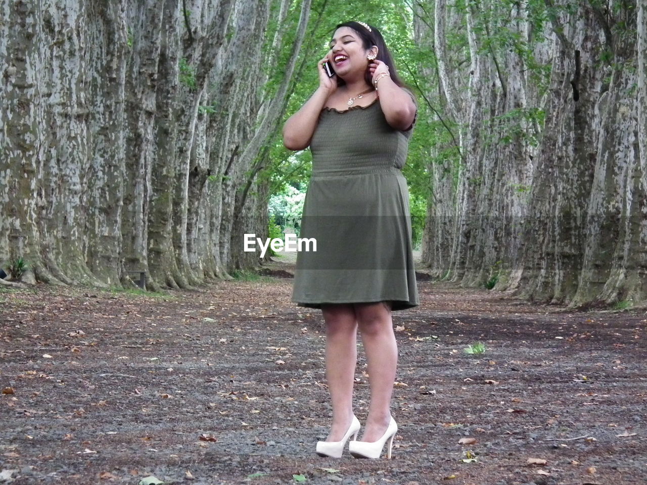 WOMAN STANDING ON A TREE