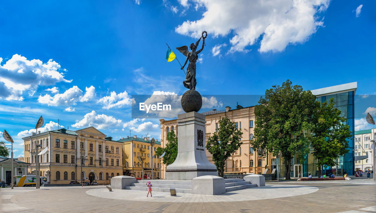 STATUE AGAINST BLUE SKY