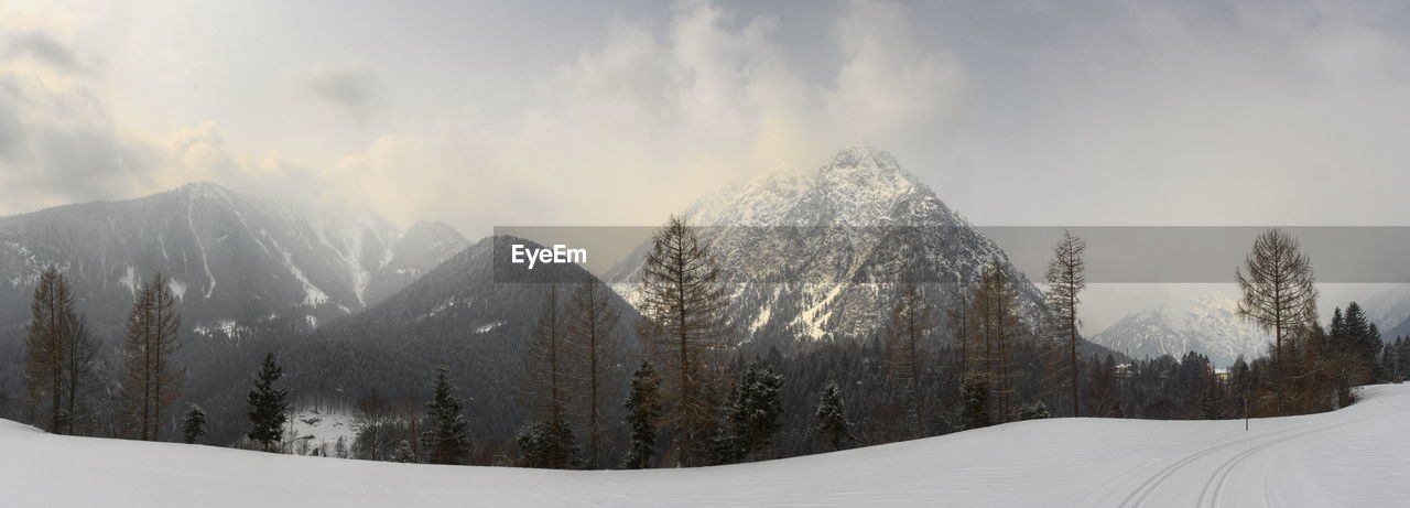 Panoramic view of mountains against sky during winter