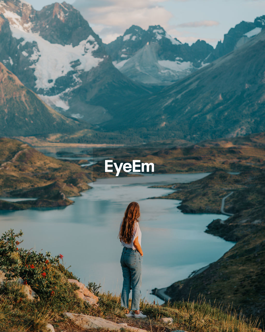 Woman standing against the lake 