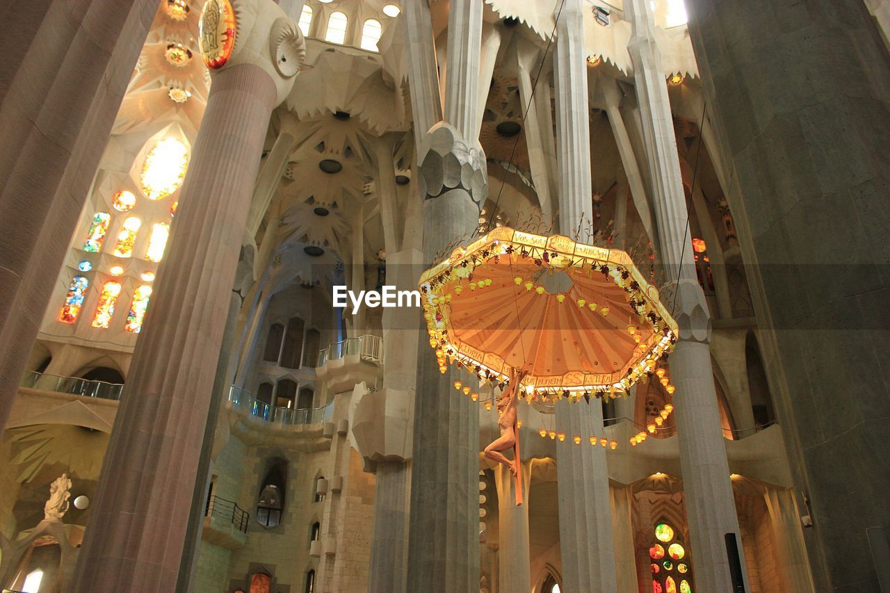 LOW ANGLE VIEW OF ILLUMINATED HANGING LANTERNS