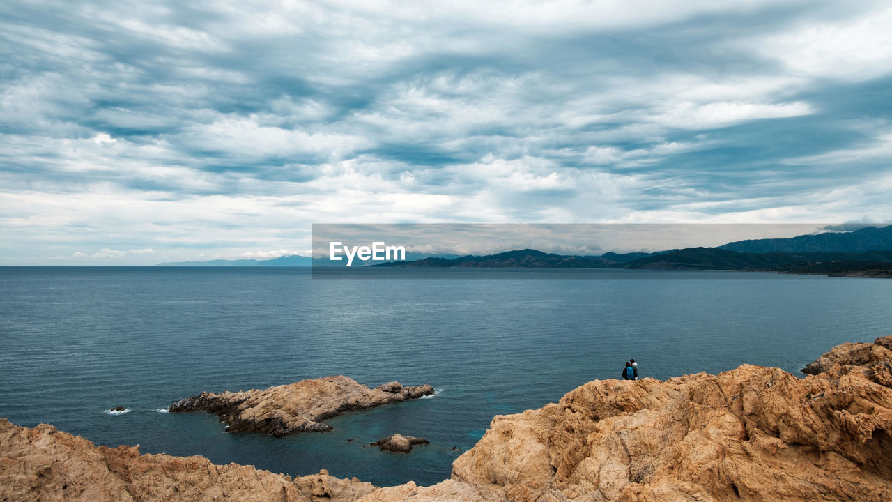 Scenic view of sea and rocks against sky