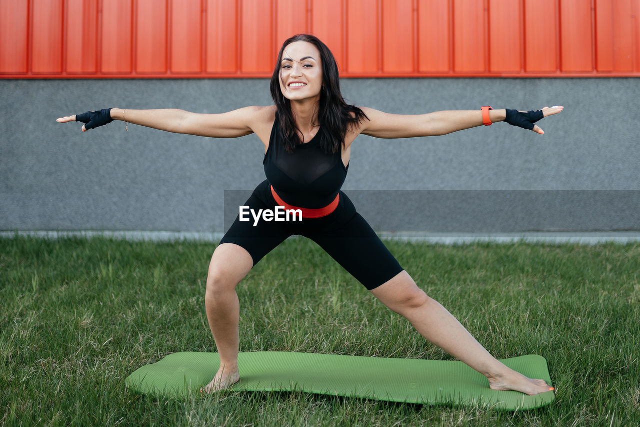 Beautiful girl is doing stretching on the street. fitness. pilates. yoga