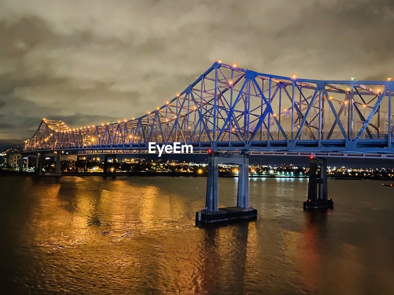 View of bridge over river at night