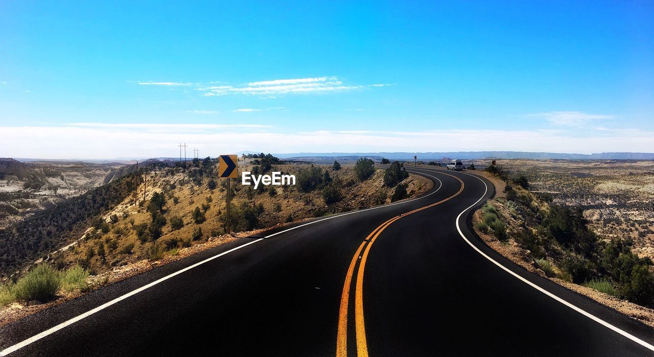 Road passing through landscape against sky