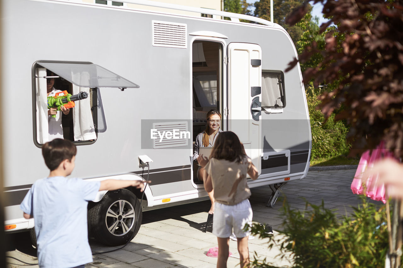 Children playing around caravan