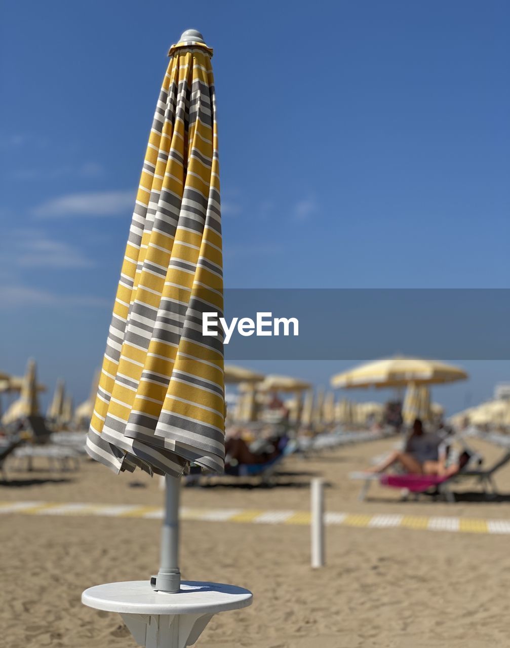 Close-up of parasols on beach against sky