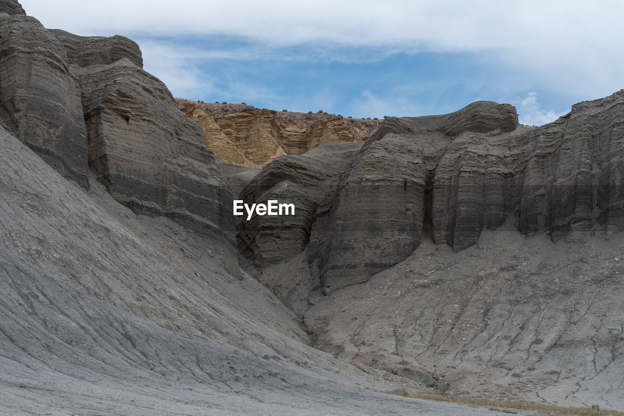Unusual landscape of grey and yellow barren stone hillsides near hanksville, utah