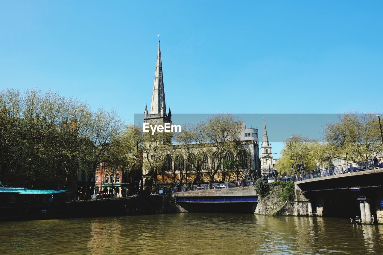 Traditional building by river against sky