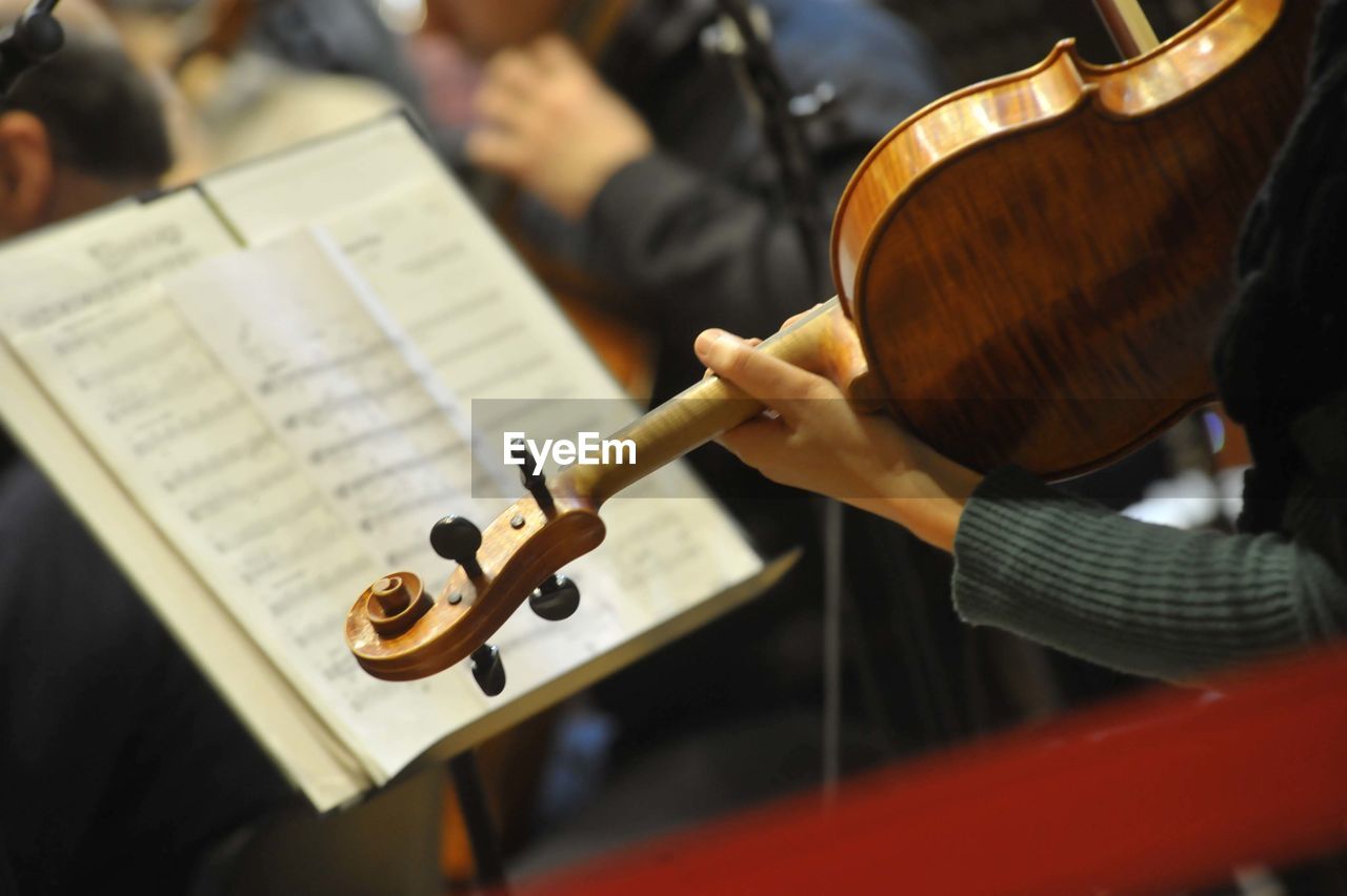 A violinist with violin plays in an orchestra, classical music