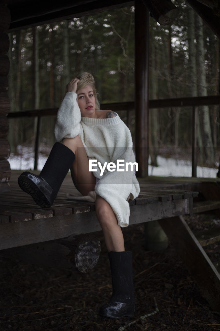 Portrait of young woman sitting on bench