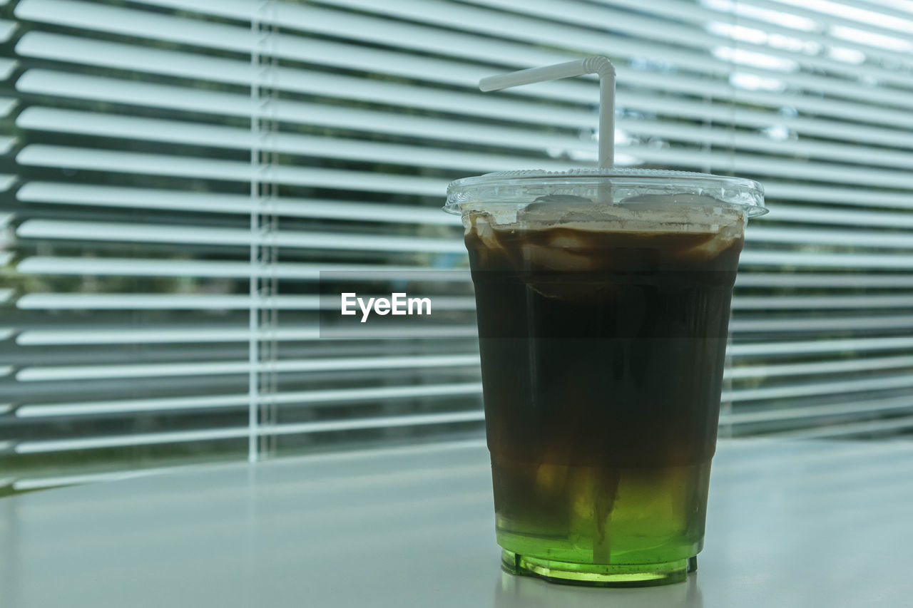 This is espresso mixed with melon water, call this menu melo coffee. and blur the background.