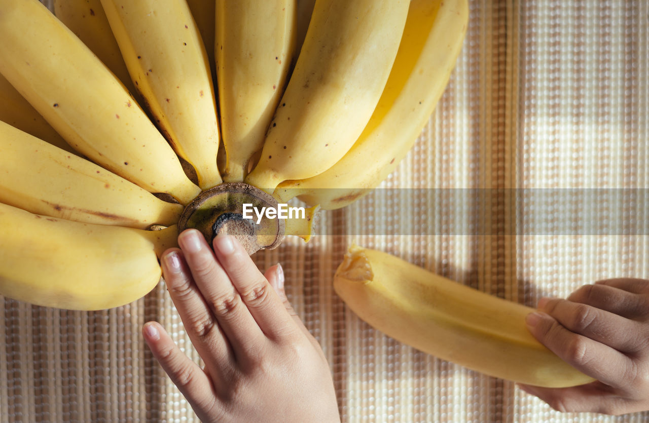 Cropped image of hands talking banana