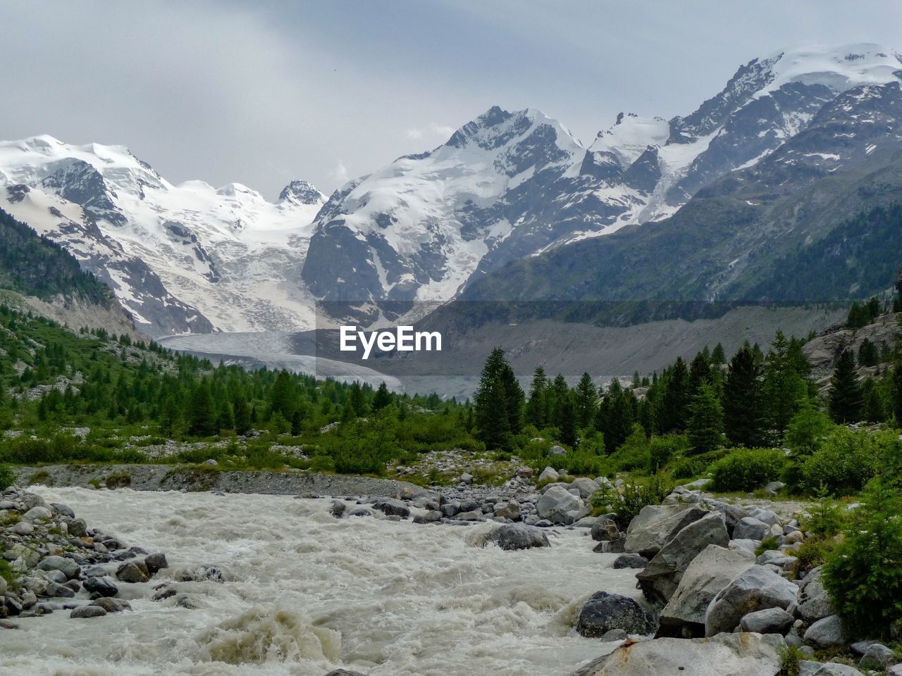 Scenic view of mountains against cloudy sky