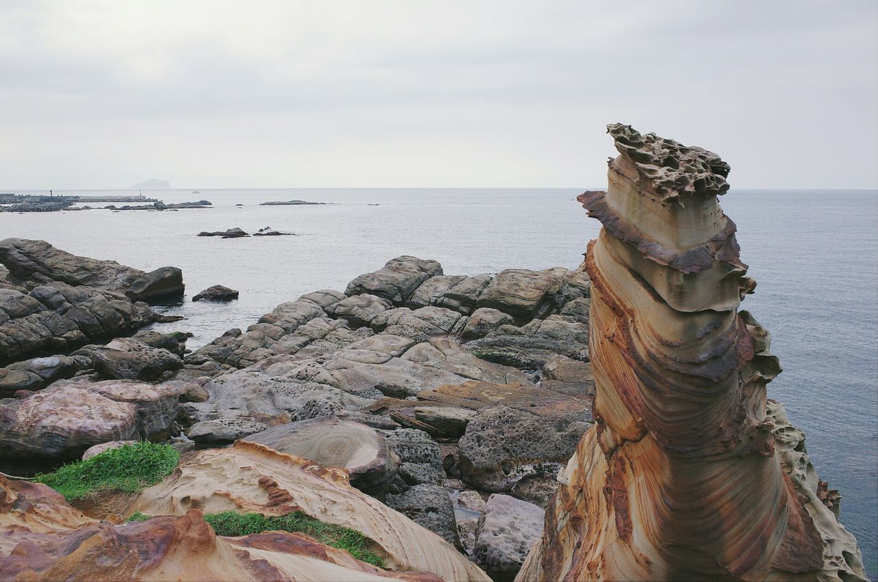 View of rocky beach against the sky