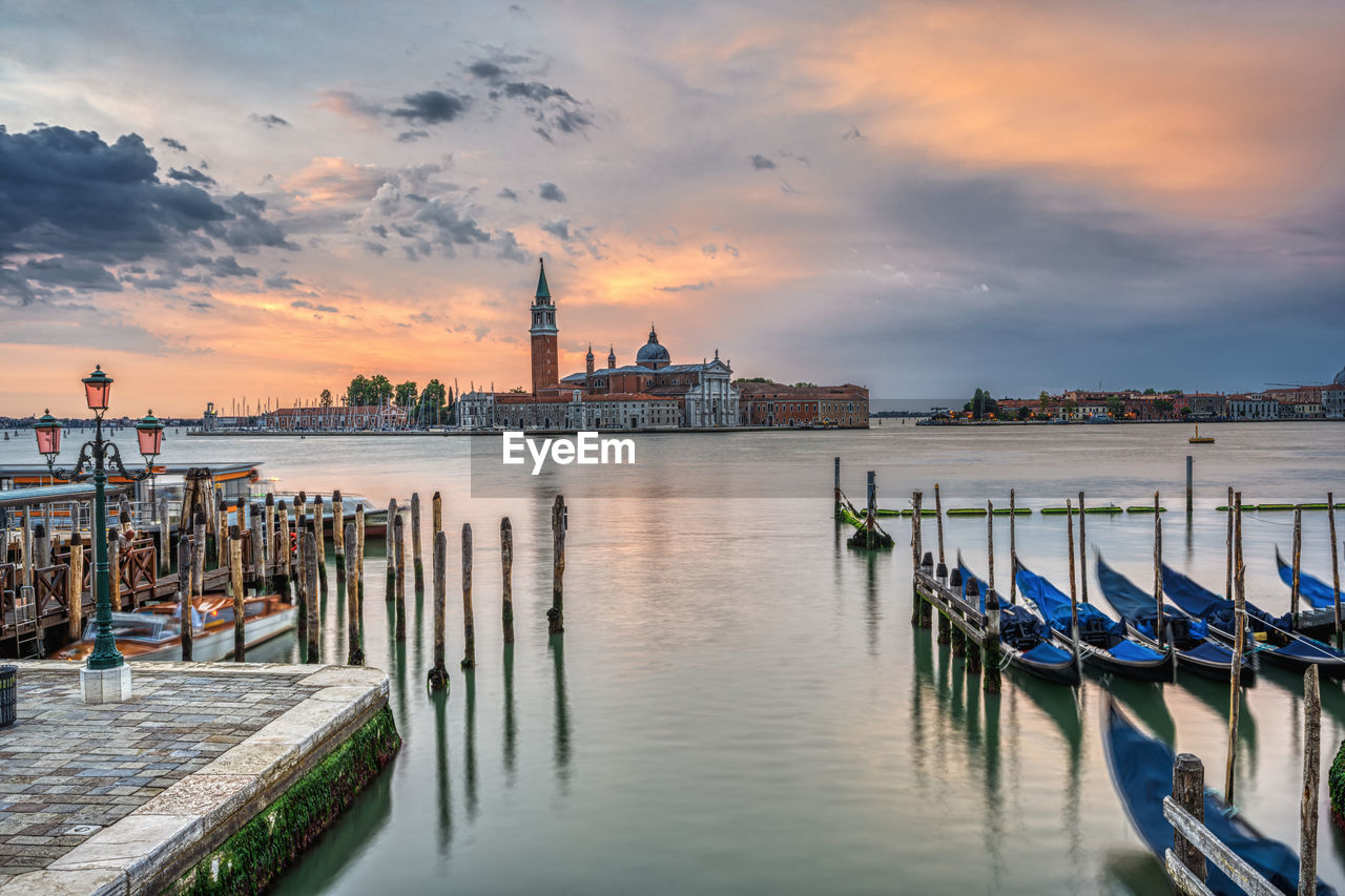 Dramatic sunrise in venice, italy, with some of the traditional gondolas