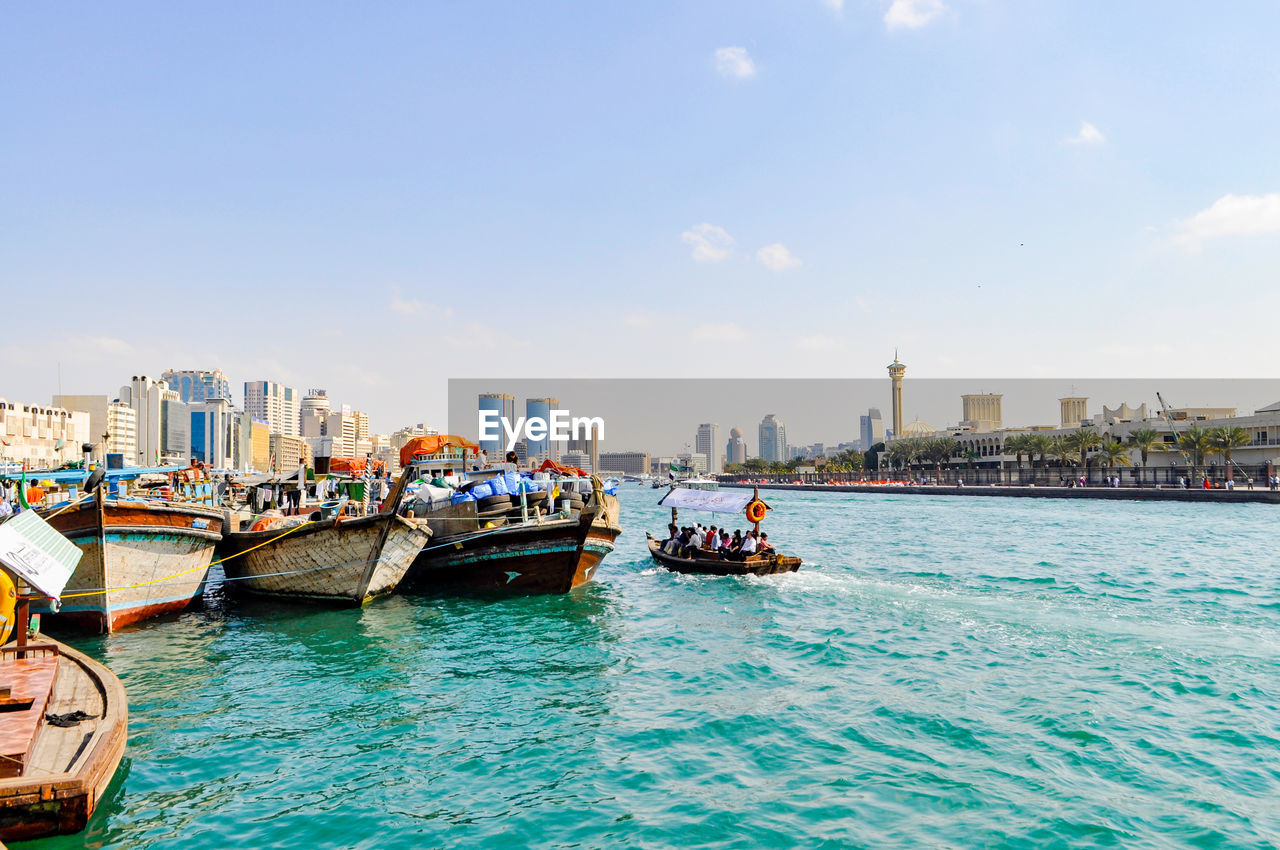 BOATS MOORED ON SEA AGAINST SKY