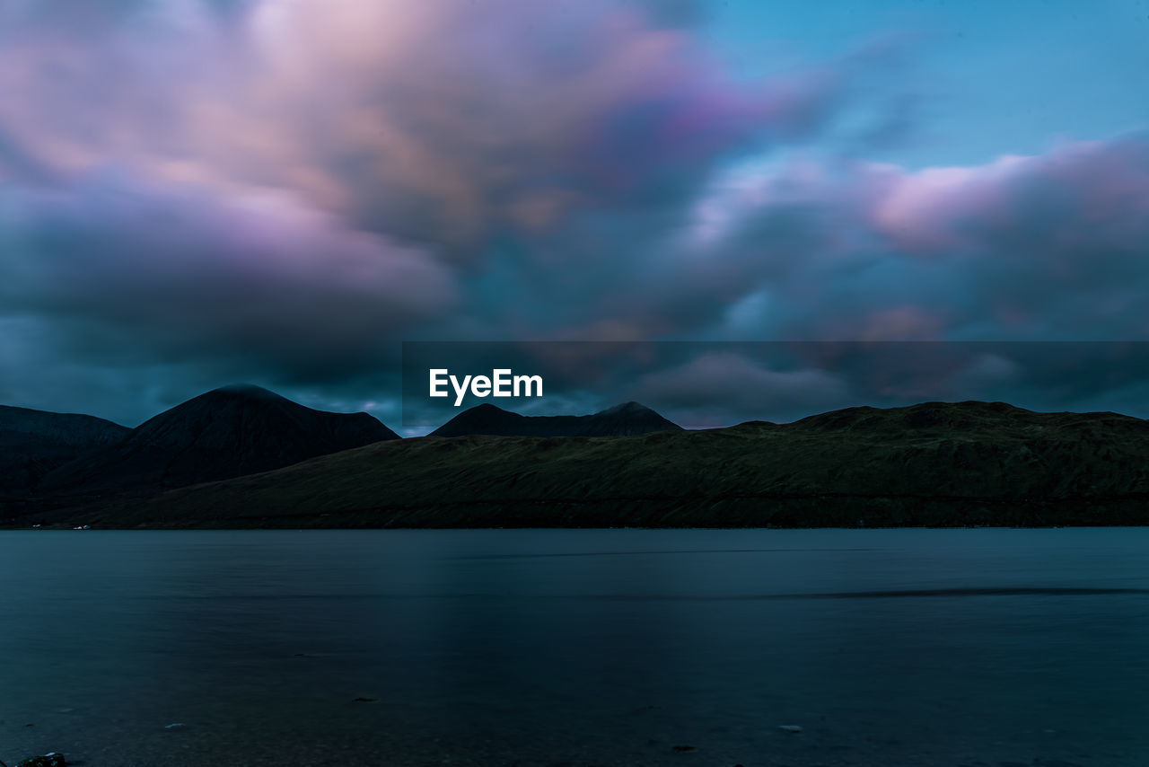 SCENIC VIEW OF LAKE BY MOUNTAINS AGAINST SKY