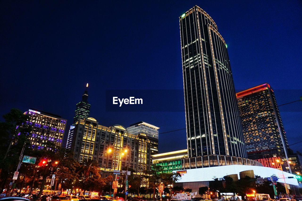 Low angle view of skyscrapers lit up at night