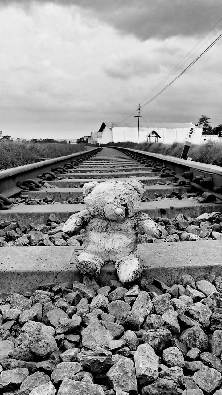 MAN ON ROAD AGAINST SKY