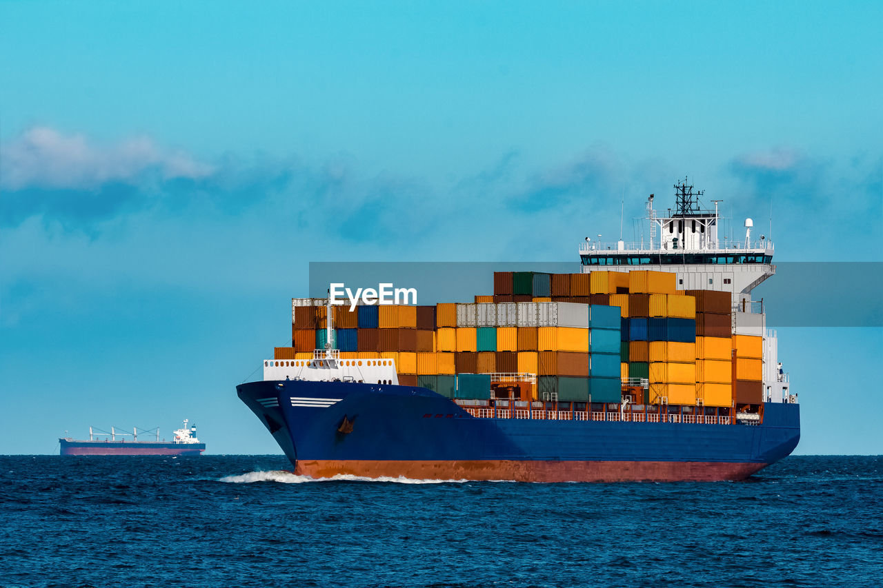 Blue container ship in travel. logistics and freight industry