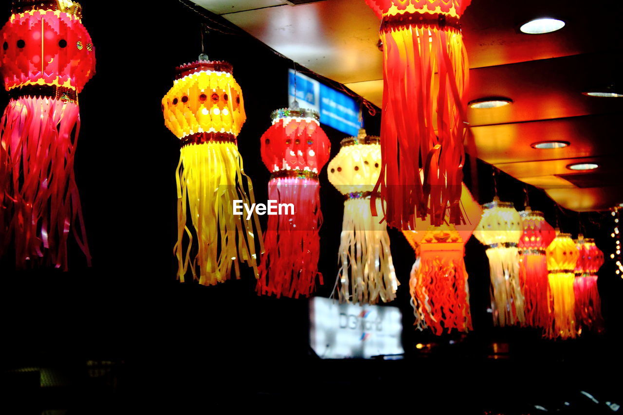 LOW ANGLE VIEW OF ILLUMINATED LANTERNS