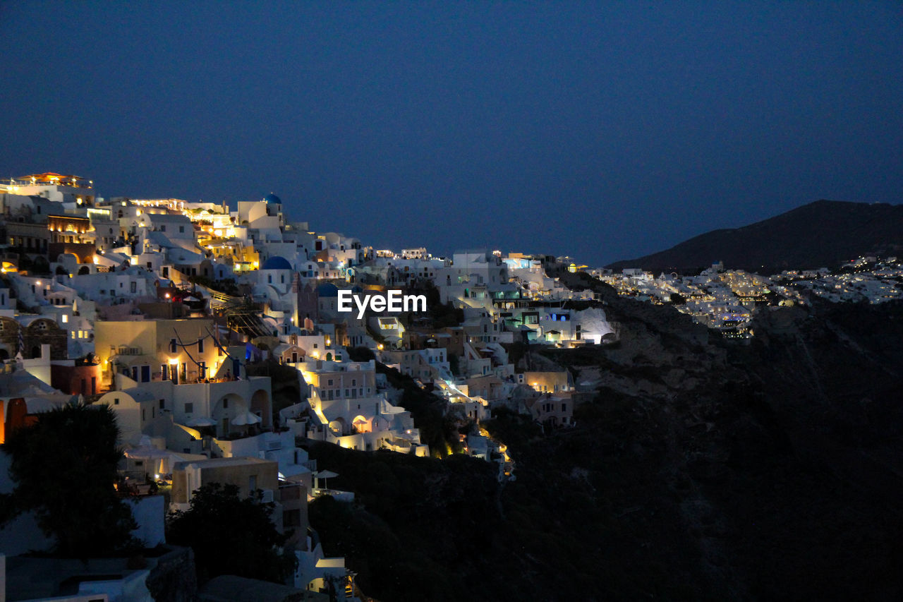 High angle view of illuminated cityscape against clear sky