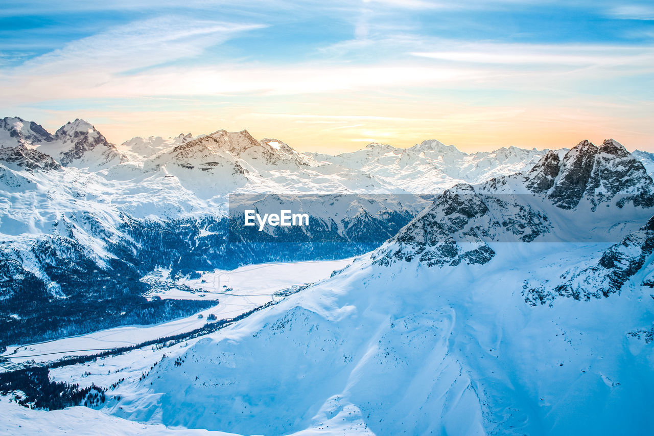 Sunset view on top of european alps full of snow 