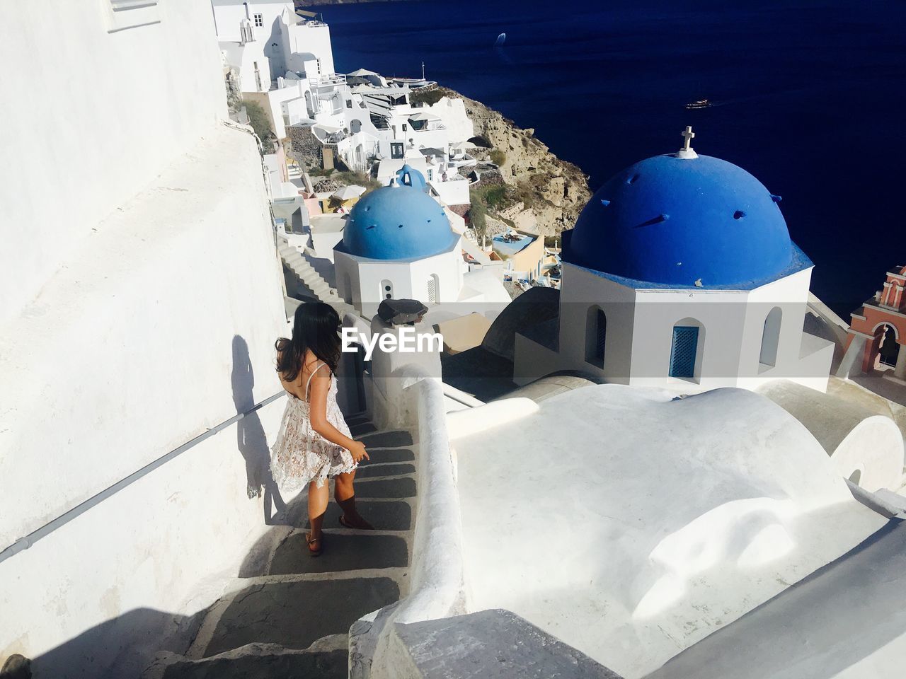 Woman walking on steps in city