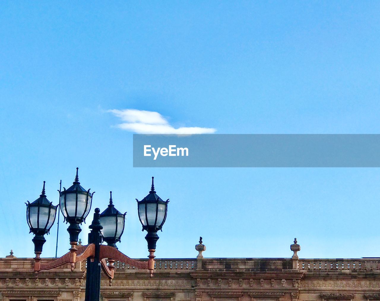 Low angle view of lamp post against blue sky