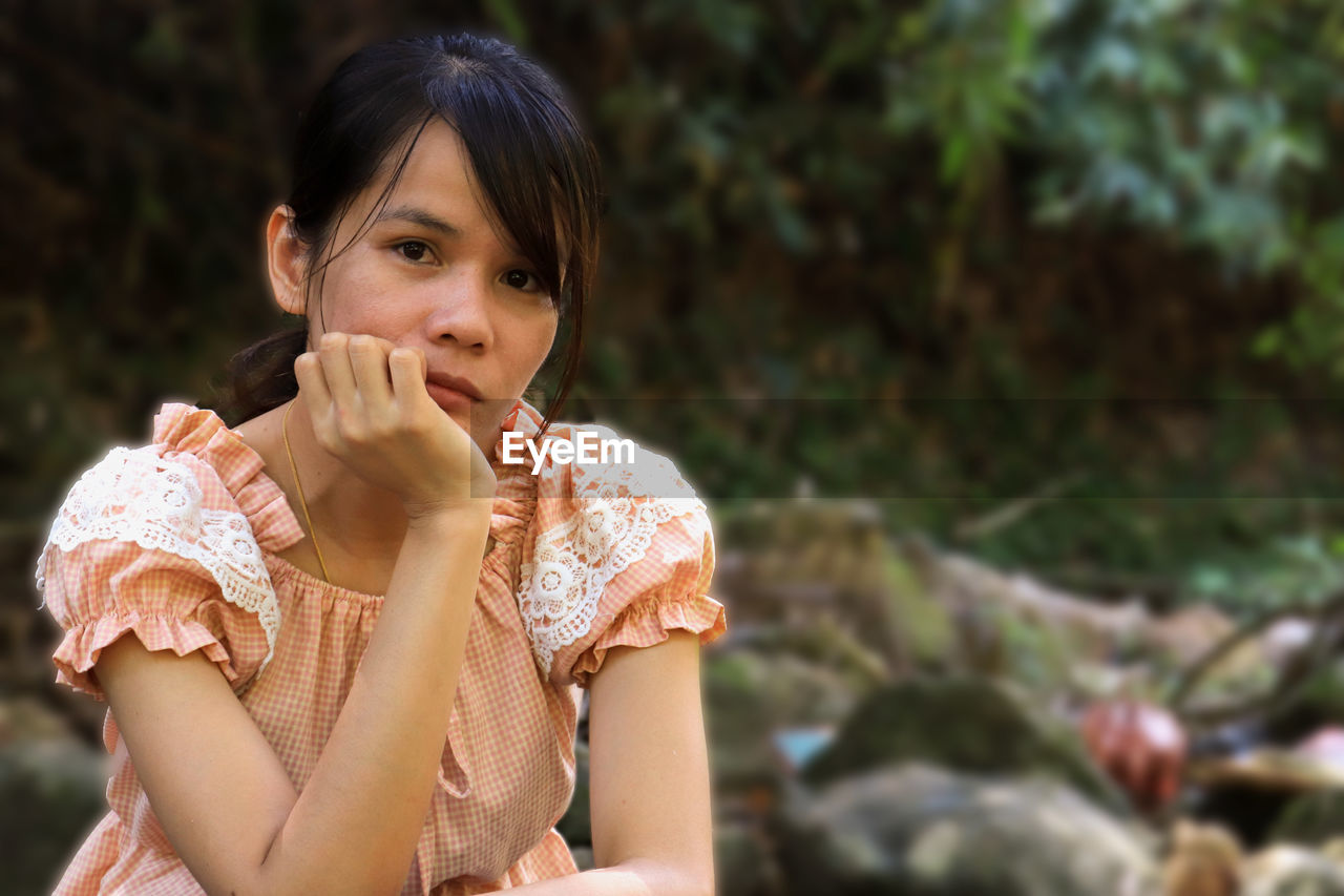 Portrait of woman sitting outdoors