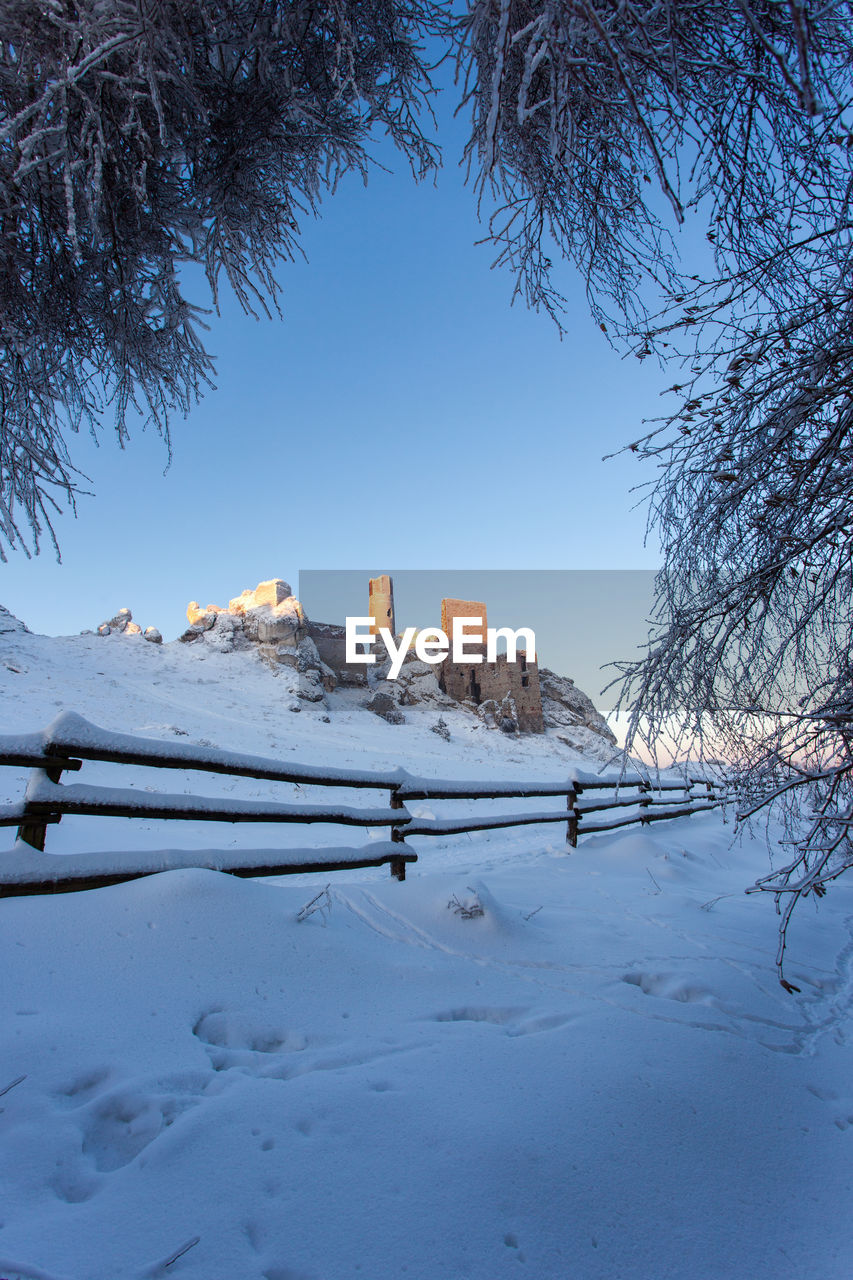 SNOW COVERED FIELD AGAINST SKY