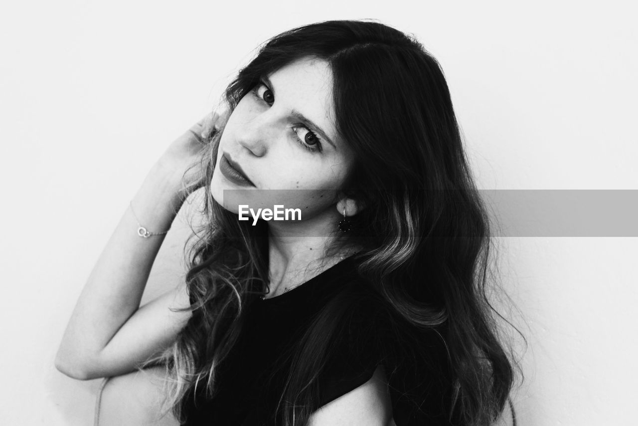 Portrait of young woman over white background