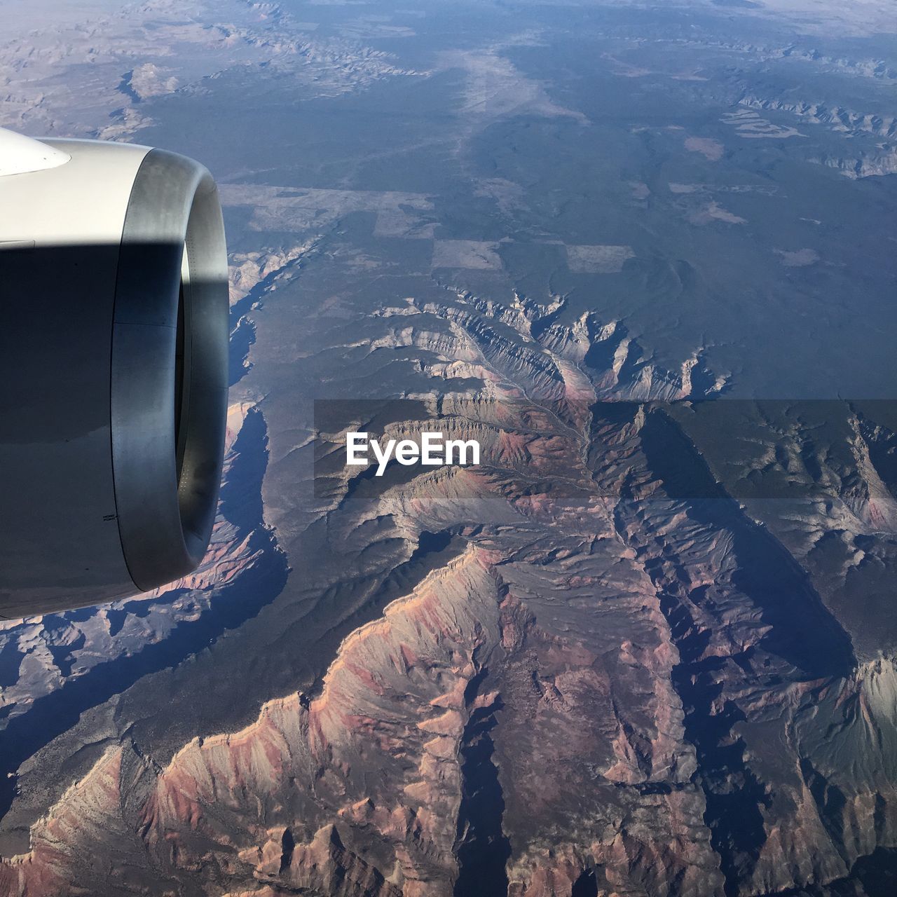 Cropped image of jet engine over landscape