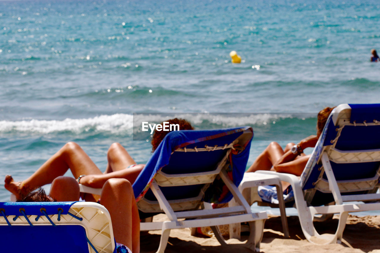 People relaxing on beach