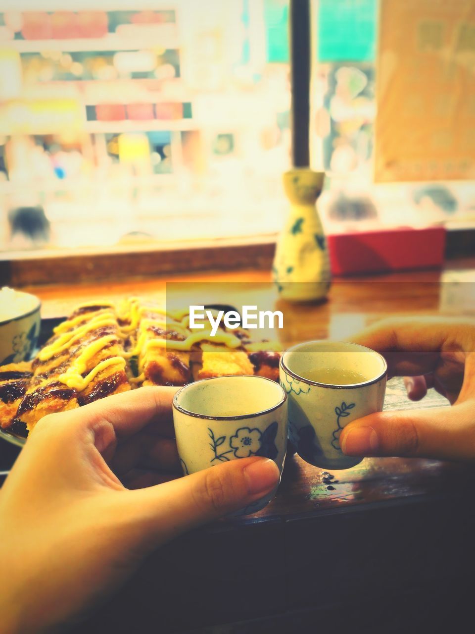 People toasting coffee cups at restaurant