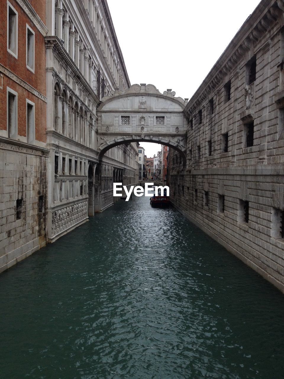 Bridge amidst buildings against clear sky