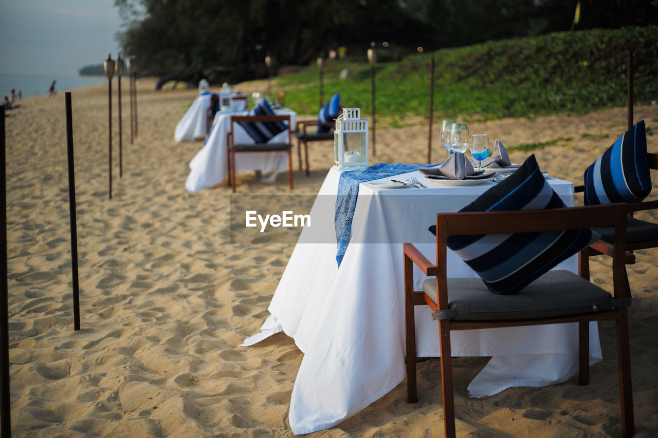 CHAIRS AND TABLES AT BEACH