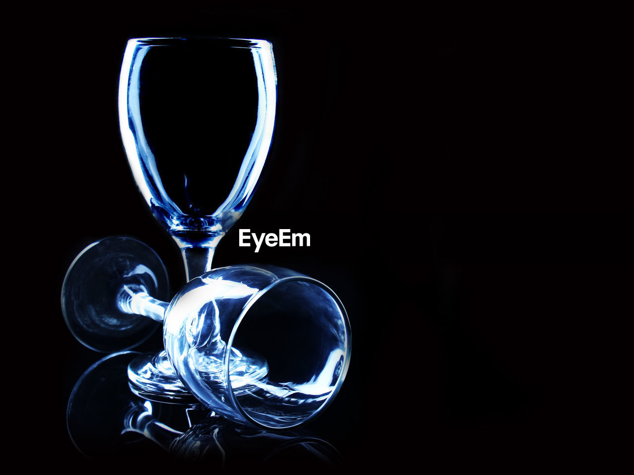 Close-up of empty wineglasses against black background