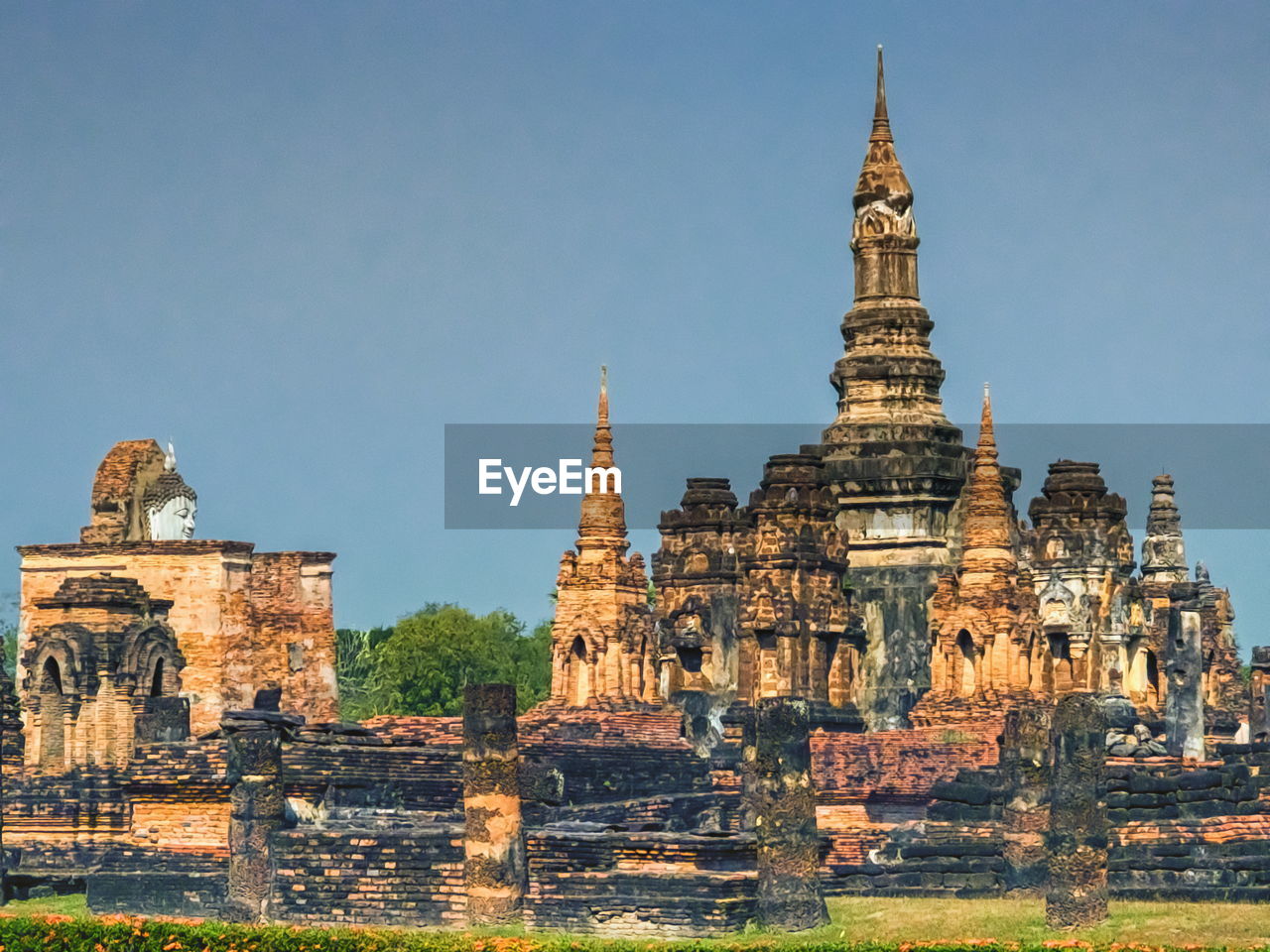 architecture, religion, temple - building, built structure, travel destinations, history, belief, ancient, travel, historic site, building, landmark, the past, spirituality, building exterior, tourism, place of worship, tower, nature, temple, sky, pagoda, industry, culture, business finance and industry, construction industry, old, no people, outdoors, landscape, clear sky, old ruin, environment, ancient history, sunny, ancient civilization, trip, vacation, blue