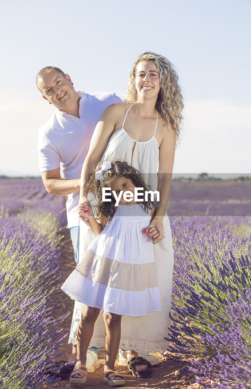 Beautiful young family on purple flower lavender field. family vacation