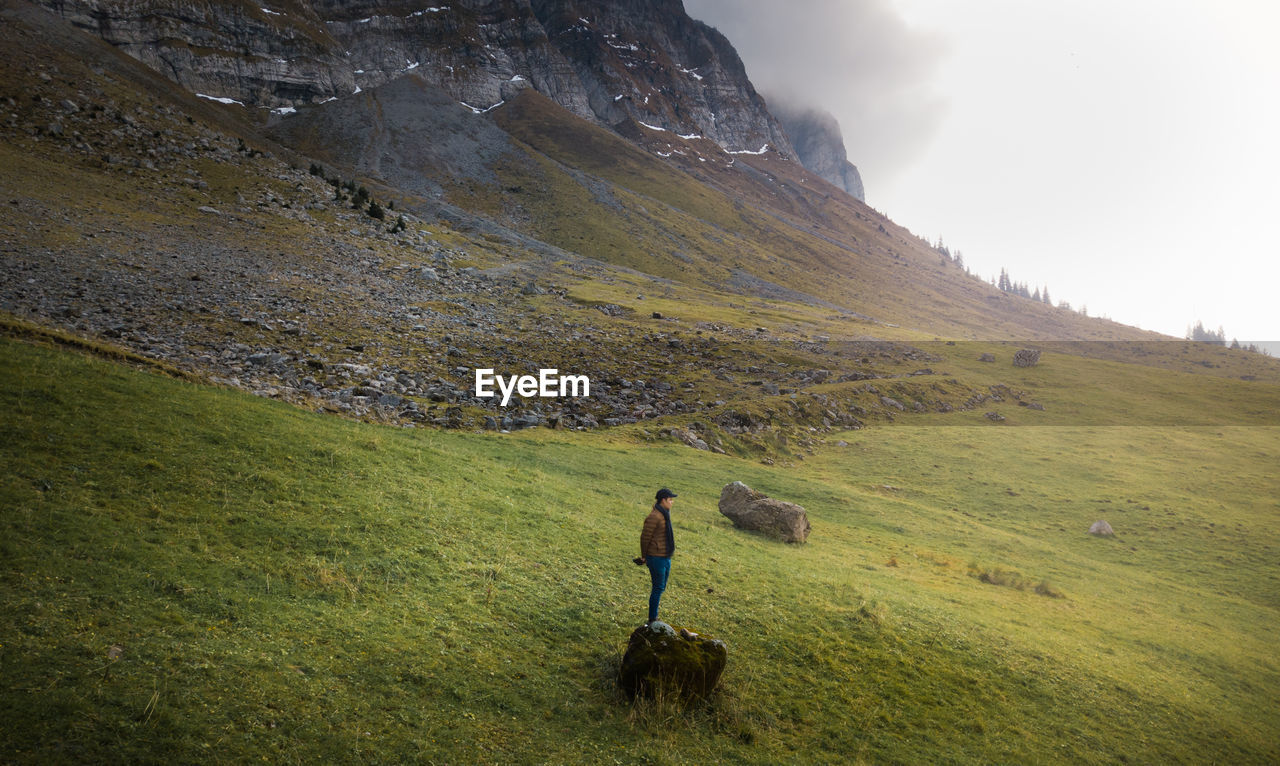 High angle view of man walking on grass field