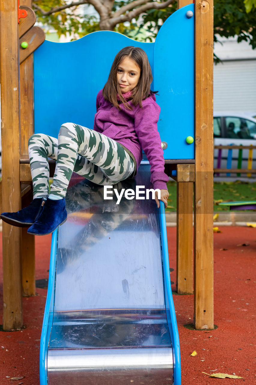 Portrait of girl sitting on slide